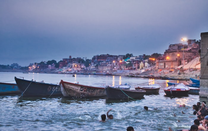 Evening view of boats and lit ghats on the Ganges in Varanasi