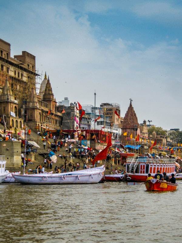 Colourful boats moored at the busy ghats of Varanasi