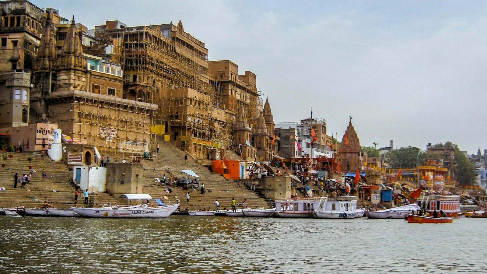 Varanasi ghats on the Ganges river with heritage buildings and boats